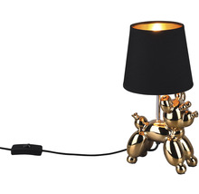 Lampă de masă decorativă în formă de câine balon auriu cu abajur negru.