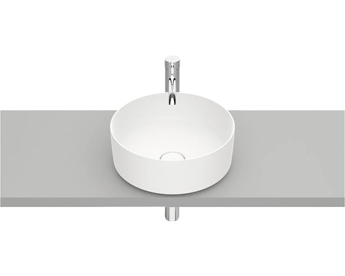 Chiuvetă rotundă așezată pe un raft cu robinet