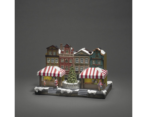 Sat de târg de Crăciun cu case, tarabe și brad ca decorațiune