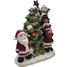 Decorațiune de Crăciun cu Moș Crăciun, om de zăpadă, ursuleț de pluș și ren lângă un brad de Crăciun cu lumini