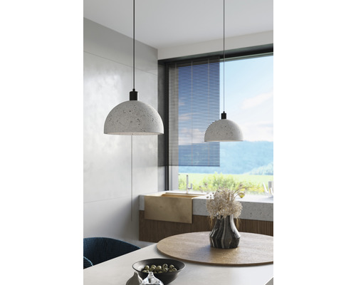 Două lămpi suspendate din piatră deasupra unei mese de sufragerie într-o cameră luminoasă.