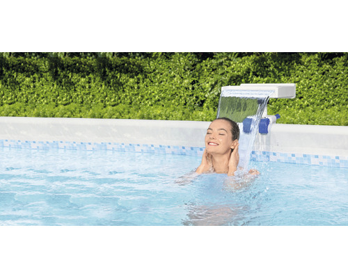 Femeie relaxându-se în piscină sub o cascadă