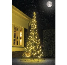 Brad artificial de Crăciun iluminat cu cer înstelat în fundal