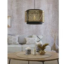 Lustră decorativă deasupra unei mese rotunde într-un living.