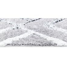 Imagine detaliată a unui covor cu model geometric