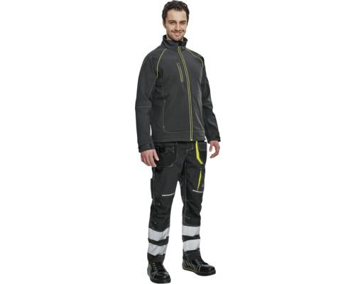 Bărbat purtând haine de lucru constând dintr-o jachetă, pantaloni și pantofi de protecție