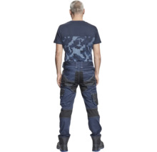 Un bărbat din spate, îmbrăcat cu un tricou cu model de pixeli și pantaloni de lucru cu buzunare