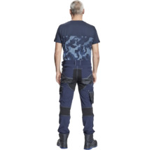 O persoană poartă pantaloni de lucru și un tricou. Pantalonii de lucru sunt echipați cu mai multe buzunare.