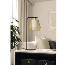 Lampă decorativă de masă cu abajur din plasă metalică pe o masă