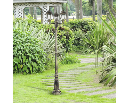 Lampa decorativă de grădină cu trei becuri într-o grădină îngrijită