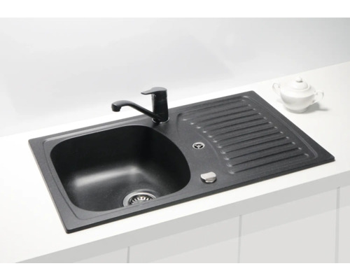 Chiuvetă neagră cu uscător și robinet pe un blat de bucătărie