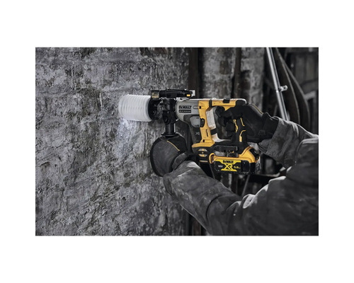 Un meșter forează o gaură într-un zid de cărămidă cu un ciocan rotopercutor cu acumulator DeWalt.