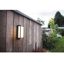 Lumină de exterior pătrată pe un perete de lemn