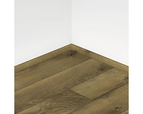 Parchet laminat montat, cu aspect de lemn, în colțul unei camere.